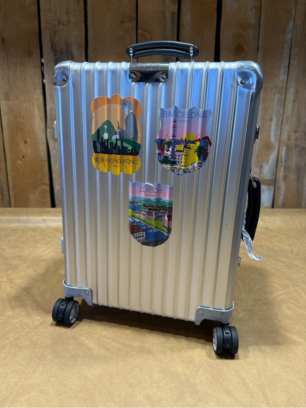 RIMOWA Silver Hard-Shell Carry-On with City Sticker Accents